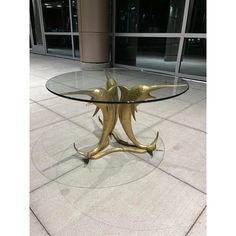 a glass table with two gold birds on it