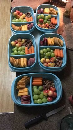 several trays filled with different types of food