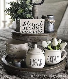 a tray that has some cups and saucers on it with flowers in vases