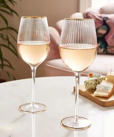 two wine glasses sitting on top of a table