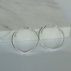 These are big sterling silver hoops, with a flat surface. Dimensions: 4 X 35 mm Weight: 5.2 gm These earrings are made of 925 hypoallergenic sterling silver. All my pieces are sent in a gift box. I can include a personal message from you if needed. You are welcome to contact me at... bhavnakwintra1956@gmail.com More Silver Hoops: https://www.etsy.com/your/shops/TheSilverGame/tools/listings/section:26305414 More Silver Earrings: https://www.etsy.com/your/shops/TheSilverGame/tools/listings/section Simple Adjustable Sterling Silver Hoop Earrings, Minimalist Small Hoop Earrings In Metal, Minimalist Small Hoop Clip-on Earrings, Minimalist Small Hoop Metal Earrings, Minimalist Small Metal Hoop Earrings, Hypoallergenic Sterling Silver Hoop Earrings, Minimalist Hypoallergenic Metal Hoop Earrings, Adjustable Minimalist Circle Hoop Earrings, Minimalist Adjustable Circle Hoop Earrings