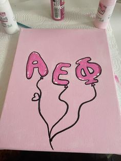 a pink canvas with the word aeg painted on it