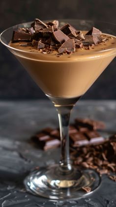 a martini glass filled with chocolate on top of a table