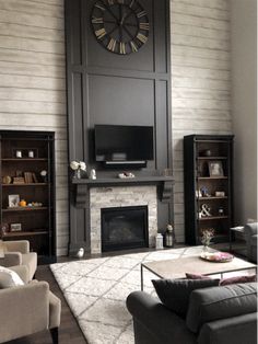 a living room filled with furniture and a large clock mounted on the wall above it