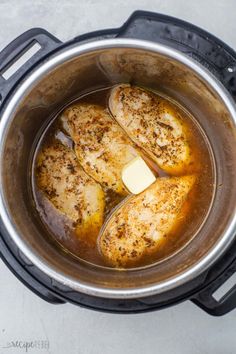 three pieces of chicken in an instant pot with butter and seasoning on the side