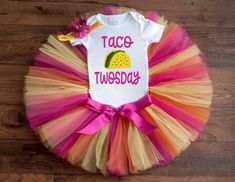 The "Becky" tutu set is made with layers of fuchsia, orange, yellow and purple tulle. This set includes a white bodysuit with a taco twosday design and a headband to match the colors in the outfit. Our tutus are made on a ribbon-tie waistband that ties and unties at the bow for a custom fit. Please note: we try our best to keep the headbands like the picture, but sometimes supply availability may vary. Let us know if you'd like something specific!Bodysuit size-------------------------Tutu/Outfit Taco Twosday Birthday Girl, Taco Twosday Birthday, Toddler Birthday Party Themes, Taco Birthday, Tutu Size Chart, Taco Twosday, 2nd Birthday Outfit, First Birthday Outfit Girl, Purple Tulle