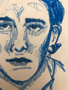 a drawing of a man's face is shown in blue and white pencils