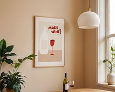 a wine bottle and glass on a table next to a window with a potted plant