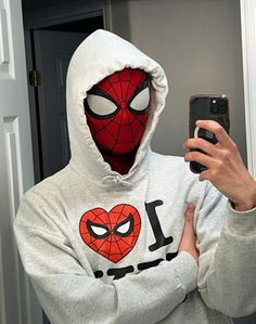 a person wearing a spider man hoodie taking a selfie