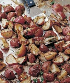 a pan filled with potatoes and meat on top of a table