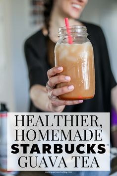 a woman holding a drink with the words healthier, homemade starbucks guava tea