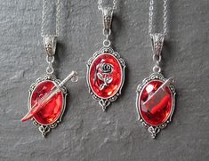 "\"Crimson Elegance: Gothic Red Crystal Frame Charm Silver Necklace - Embrace the Dark Glamour!\" This Gothic Red Crystal Frame Charm Silver Necklace from CheekyGems is a captivating and unique accessory that beautifully combines gothic aesthetics with a touch of glamour. The necklace features a delicate silver Stainless steel chain that perfectly complements the stunning red acrylic crystal (with either, Sword, Rose or Axe) frame charm pendant (plated over zinc alloy). The frame charm is intric Gothic Fashion Victorian, Dark Glamour, Gothic Mode, Crystal Frame, Filigree Pattern, Goth Style, Gothic Victorian, Gothic Accessories, Charm Necklace Silver