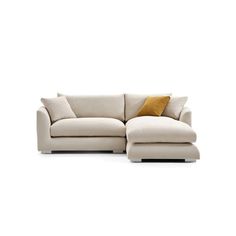 a white couch with yellow pillows on it's back and the seat folded out