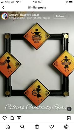 an orange and black square frame with some stickers on the front, and two yellow squares in the middle