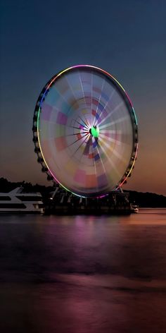 a ferris wheel sitting on top of a body of water