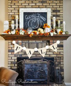 a fireplace decorated for fall with pumpkins, candles and bunting banner on the mantel