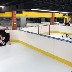 an indoor ice rink with yellow and white lines