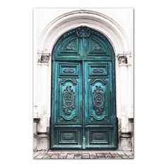 an old green door with two lions on it's sides and a brick walkway