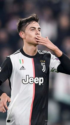 a soccer player with his hand to his mouth