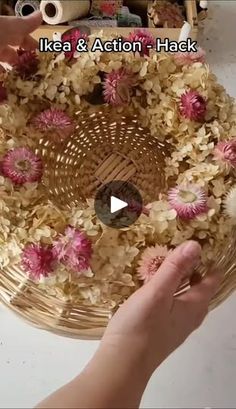 a person holding a basket with flowers in it and the words ikea & action - hack