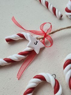 some candy canes are wrapped in red and white ribbon