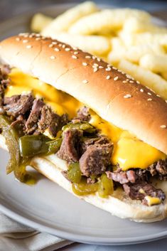 a close up of a sandwich on a plate with french fries