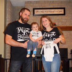 "These shirts are a fun way to announce your pregnancy or newest addition to your friends and family. Also makes a great baby shower gift! ❤ Any design found in my shop can be made on a baby bodysuit, child-sized or youth shirt. They can even be on an adult tank or shirt! Please message me to discuss your options, or if you would like a mommy-baby or daddy-baby matching outfit! ❤ All orders are custom made.  ❤ The \"primary colour\" drop down menu refers to vinyl colour used.  ❤ Bodysuits are white, and can be long sleeve or short sleeve. Shirts can be nearly any colour. Please send me a message with your preferences. ❤ Please send me a message in the \"note to seller\" section before check out if you would like add to or change the wording, or add your little one's name to make it extra p Black Short Sleeve Onesie For Family Matching, Family Matching Black Short Sleeve Onesie, Family Matching Onesie For Gender Reveal With Letter Print, Family Matching Onesie With Funny Text For Birthday, Family Matching Birthday Onesie With Funny Text, Family Matching Short Sleeve Onesie, Family Pregnancy Announcement, Pregnancy Announcement Family, Sibling Announcement