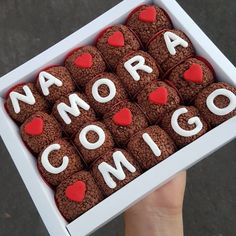 a box filled with cookies that spell out the word'narra conigi '