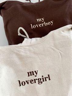 two towels with the words my lovergirl and my lover boy printed on them sitting next to each other