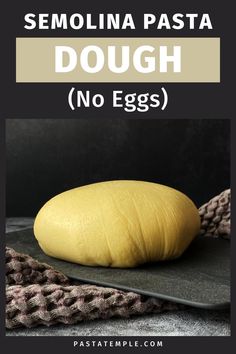 a doughnut sitting on top of a black plate with the words, semolinia pasta dough no eggs