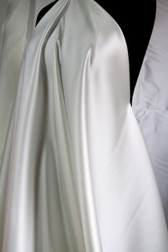 Elegant Satin Finish Fabric For Wedding, Elegant Satin Fabric For Wedding, Elegant Wedding Fabric With Satin Finish, Elegant Wedding Satin Fabric, Wedding Silk Fabric With Satin Finish, White Satin Finish Fitted Gown, White Silk Gown For Ceremonies, White Satin Finish Wedding Gown, Elegant Cream Fabric For Wedding