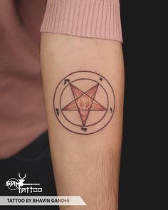 a man's arm with a tattoo on it and a pentagramil in the middle