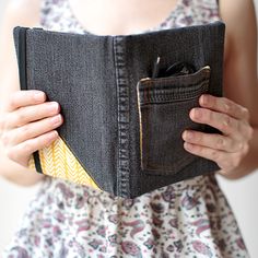 a woman is holding her pocket open to show the inside of her jean pants and phone