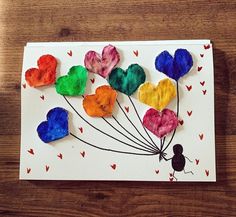 a card with hearts attached to it on a wooden table