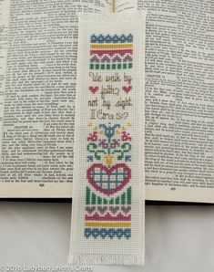 a cross stitch bookmark with the words i love you and an image of a heart on it