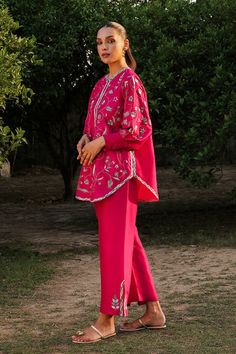 We continue to infuse extra love in effortless ensembles that become perfect partners for your casual and formal gatherings. The cherry pink pure rawsilk shirt is adorned with delicate floral embroidery taking the mood from pretty to playful with its exaggerated cuff sleeves and pure rawsilk trousers with an embroidere Embroidery Coord Sets, Traditional Festive Pant Set With Set-in Sleeves, Spring Festive Kurta With Set-in Sleeves, Elegant Festive Palazzo Set For Spring, Pink Raw Silk Set With Floral Embroidery, Spring Festive Palazzo Set With Set-in Sleeves, Pink Designer Wear Sets For Spring, Summer Resham Embroidery Long Sleeve Pant Set, Pink Straight Kurta Pant Set For Designer Wear