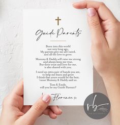 two hands holding up a card with a cross on it