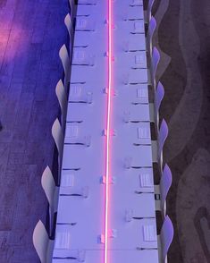 the long table is lit up with purple light