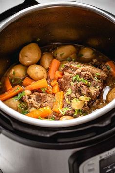 a pot filled with meat and vegetables on top of a stovetop oven next to an electric pressure cooker