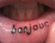 the word bonjou written in cursive writing on someone's tongue is shown