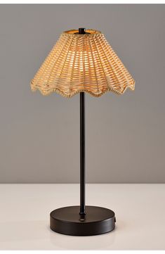 a lamp that is sitting on top of a wooden base and has a light bulb in the shape of a fan