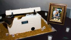 a cake that looks like an old fashioned kitchen stove is on a table next to a framed photo