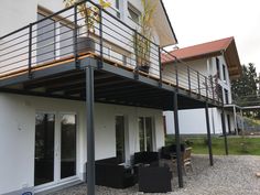 an outside view of a house with patio furniture