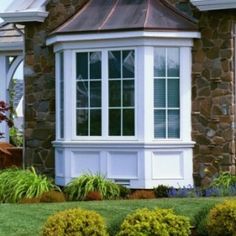 a brick house with white trim and windows