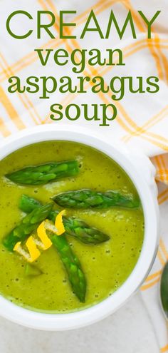 creamy vegan asparagus soup in a white bowl on a checkered tablecloth