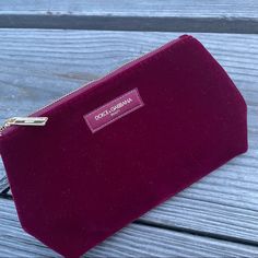 New, Authentic Dolce & Gabbana Cosmetic Pouch From D&G's Beauty Line. Rich Maroon/ Red Wine/Zinfandel Velvet/ Velour W/Golden Hardware, Center Logo & Top Zip Closure W/Branded Zipper Pull. Very Spacious & Versatile! Classy & Elegant. Can Also Be Used As A Pochette, Or Clutch! Approx 9" X 6.5" X 3" Luxury Red Pouch, Designer Bags With Zipper Pouch For Gifts, Designer Bags With Zipper Pouch As Gift, Elegant Cosmetic Bag With Dust Bag, Center Logo, Zinfandel, Maroon Red, Clutch Pouch, Cosmetic Pouch