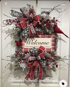 a welcome sign is hanging on the front door with red and silver ribbons, pineconis, holly berries, and cardinal cardinals