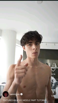 a shirtless young man giving the thumbs up sign