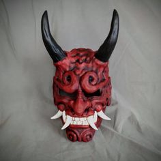 Woodland Oni  style Noh maskBased off traditional Japanese Noh Masks. Made of PLA and hand painted in acrylics. This mask is large enough to be wearable by most people.  Comes as mask only without straps.Inside dimensions are: 240 H x 150 W mm/   9.5 H x   6 W inOverall Dimension: 340 H x 190 W mm/  13.5H x  7.5 W inEach piece is individually made to order so keep in mind: It will possibly take a couple weeks to paint and get it shipped out. The paint and coloring may differ slightly the picture Traditional Cosplay Masks, Traditional Cosplay Masks And Prosthetics, Traditional Halloween Masks And Prosthetics, Handmade Traditional Mask, Red Oni Mask, Japanese Noh Mask, Japanese Yokai, Noh Mask, Clown Mask