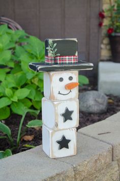 a snowman made out of blocks with a hat on top